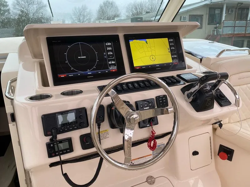 Slide: The Image of Helm of 2017 Grady-White Express 370 with dual navigation screens and steering wheel. - 16