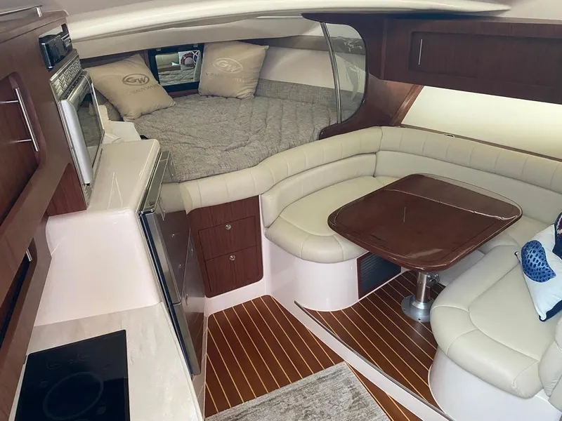 Slide: The Image of 2017 Grady-White Express 370 cabin interior with cozy seating, table, and bed. - 18