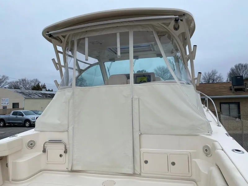 Slide: The Image of 2017 Grady-White Express 370 boat with enclosed cockpit, docked outdoors. - 2