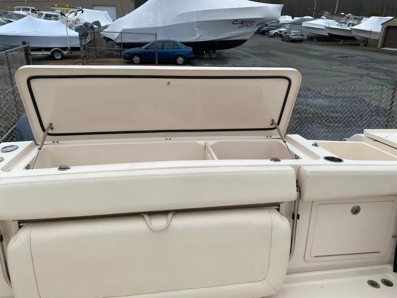 Slide: The Image of 2017 Grady-White Express 370 boat with open storage compartment, docked in a marina. - 9
