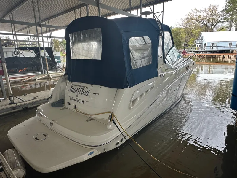 Slide: The Image of 2008 Sea Ray 260 Sundancer docked under a covered marina. - 2