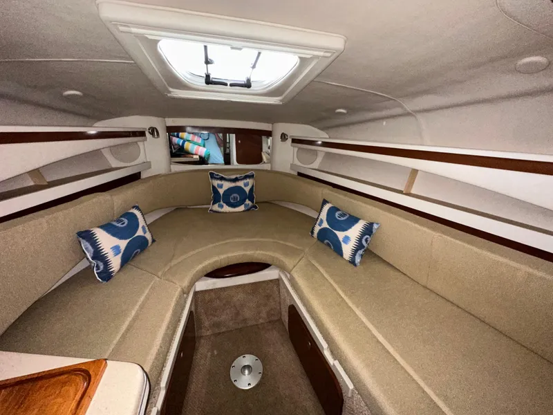 Slide: The Image of 2008 Sea Ray 260 Sundancer cabin with beige seating and decorative pillows. - 4