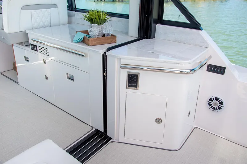 Slide: The Image of Interior of 2026 Regal 36 XO yacht showing open wooden closet and bed. - 15