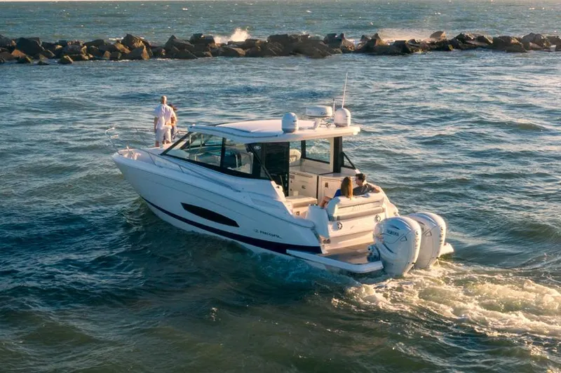 Slide: The Image of Twin V8 outboard engines on a 2026 Regal 36 XO boat, parked on grass. - 3