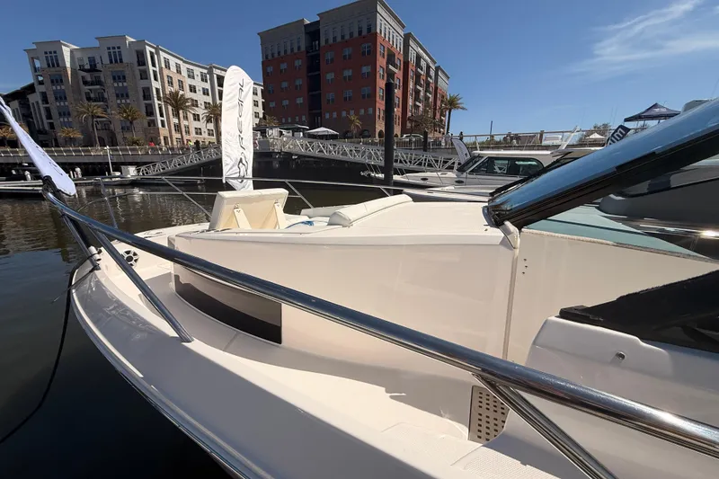 Slide: The Image of 2026 Regal 36 XO yacht docked at marina with modern buildings in background. - 52