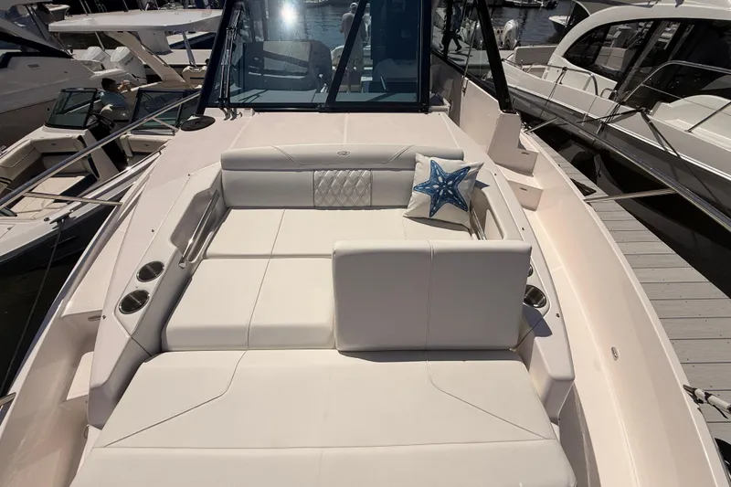 Slide: The Image of Luxurious seating area on a 2026 Regal 36 XO yacht with starfish pillow. - 56