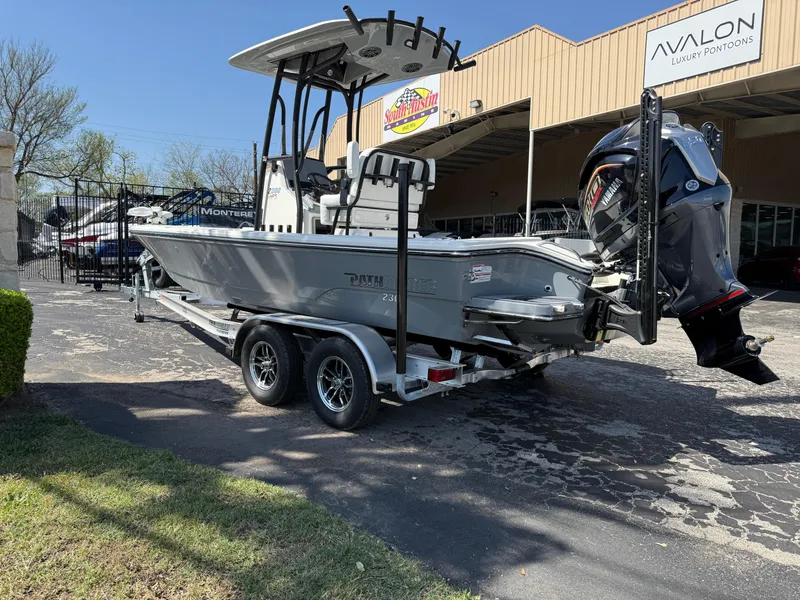 Slide: The Image of 2025 Pathfinder 2300 HPS boat on trailer, parked outside dealership. - 11