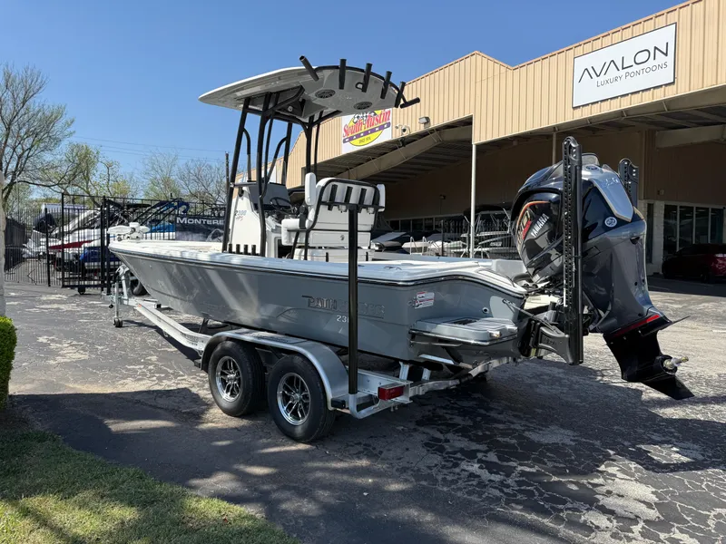 Slide: The Image of 2025 Pathfinder 2300 HPS boat on trailer, parked outside Avalon Luxury Pontoons dealership. - 12