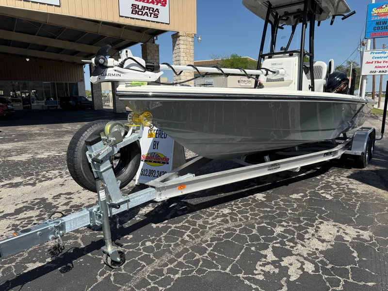 Slide: The Image of 2025 Pathfinder 2300 HPS boat on trailer, parked outside dealership. - 15