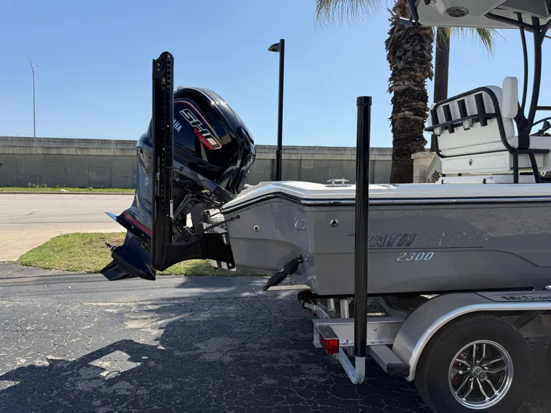 Slide: The Image of 2025 Pathfinder 2300 HPS boat on trailer with powerful outboard motor. - 18