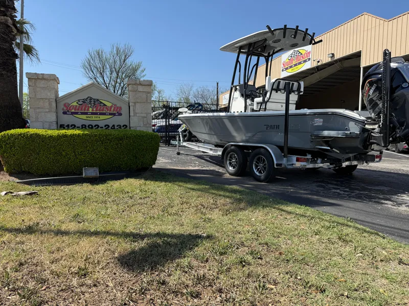 Slide: The Image of 2025 Pathfinder 2300 HPS boat on trailer outside dealership, sunny day. - 2