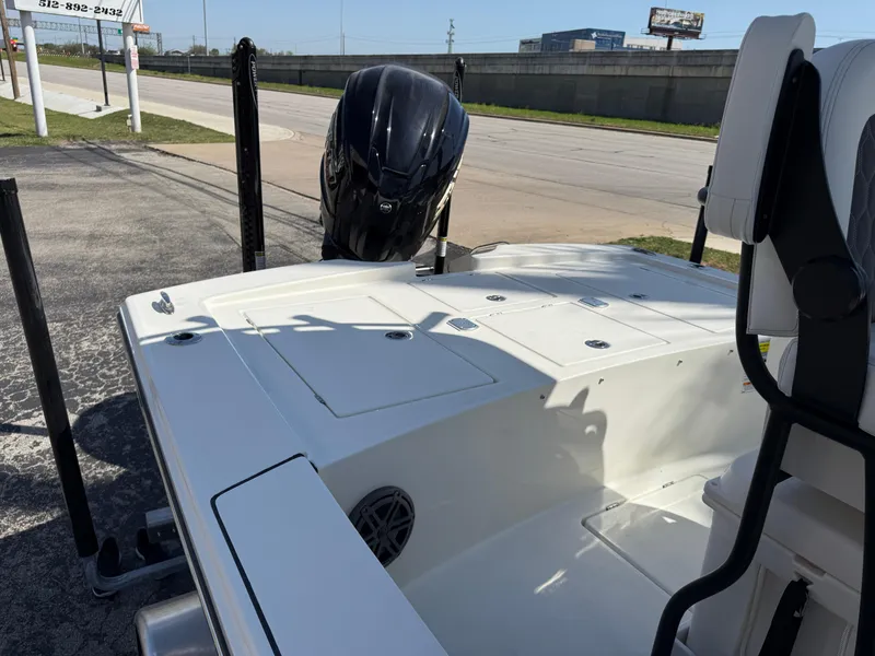 Slide: The Image of 2025 Pathfinder 2300 HPS boat, rear view with motor, parked on pavement. - 24
