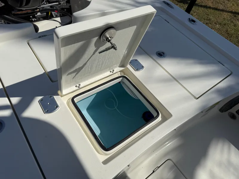 Slide: The Image of 2025 Pathfinder 2300 HPS boat with open storage compartment and latch. - 26
