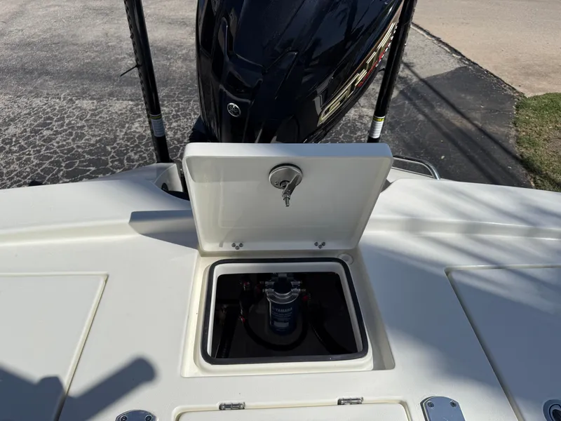 Slide: The Image of 2025 Pathfinder 2300 HPS boat with open storage compartment and visible engine. - 29