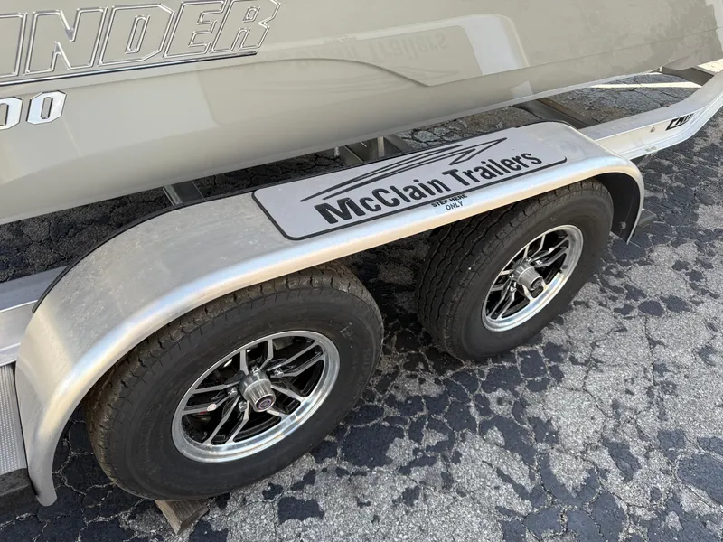 Slide: The Image of Trailer with dual wheels for 2025 Pathfinder 2300 HPS boat by McClain Trailers. - 3