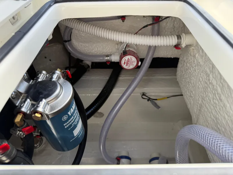 Slide: The Image of Engine compartment of 2025 Pathfinder 2300 HPS boat, showing hoses and filter system. - 31