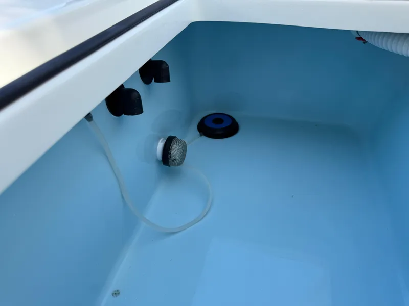 Slide: The Image of Interior view of 2025 Pathfinder 2300 HPS boat compartment with fittings and hoses. - 35