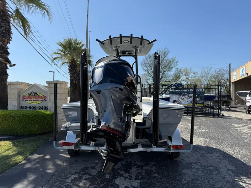 Slide: The Image of 2025 Pathfinder 2300 HPS boat with powerful outboard motor, parked outdoors. - 4