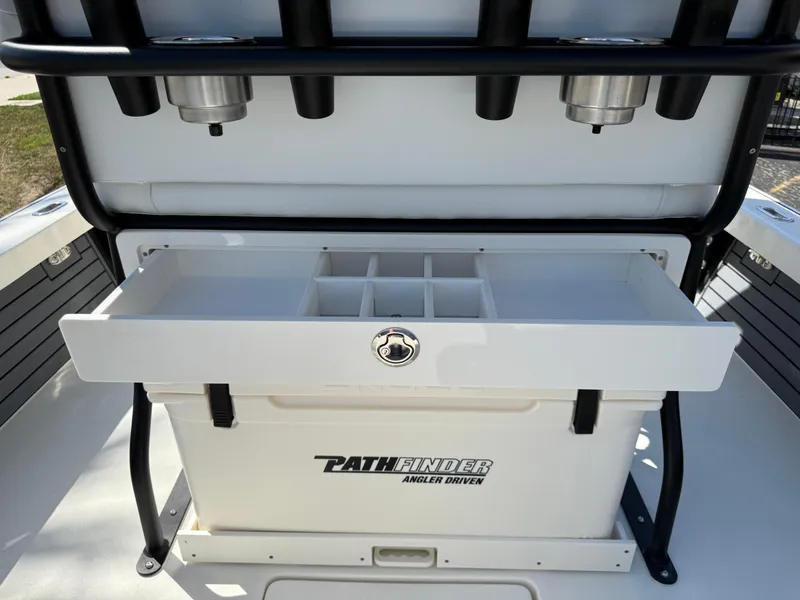 Slide: The Image of 2025 Pathfinder 2300 HPS boat storage compartment with rod holders and tackle box. - 40