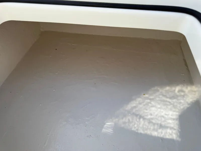 Slide: The Image of Storage compartment of 2025 Pathfinder 2300 HPS boat, featuring a clean, white interior. - 43