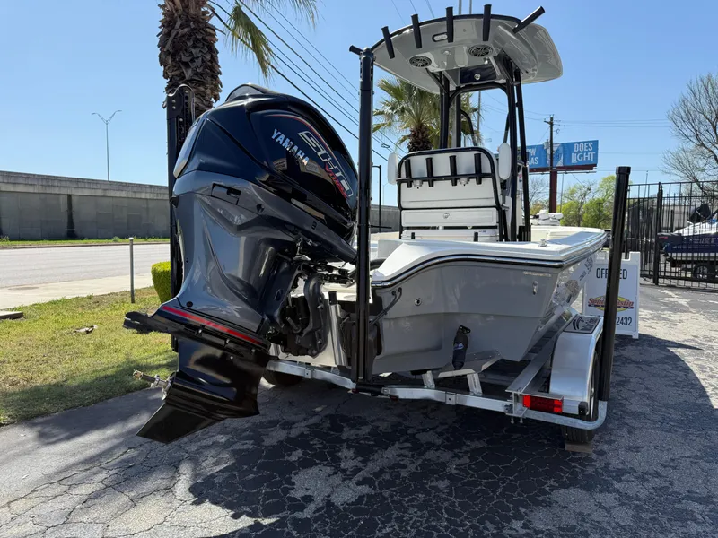 Slide: The Image of 2025 Pathfinder 2300 HPS boat with Yamaha engine on trailer, parked outdoors. - 5