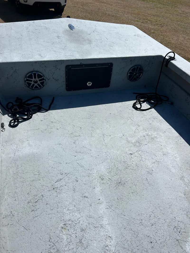 Slide: The Image of 2022 May-Craft 25 Hancock Edition boat interior with speakers and ropes on deck. - 10