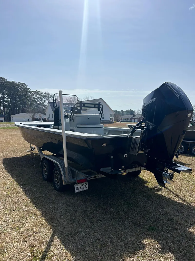 Slide: The Image of 2022 May-Craft 25 Hancock Edition boat on trailer, parked outdoors under clear sky. - 4