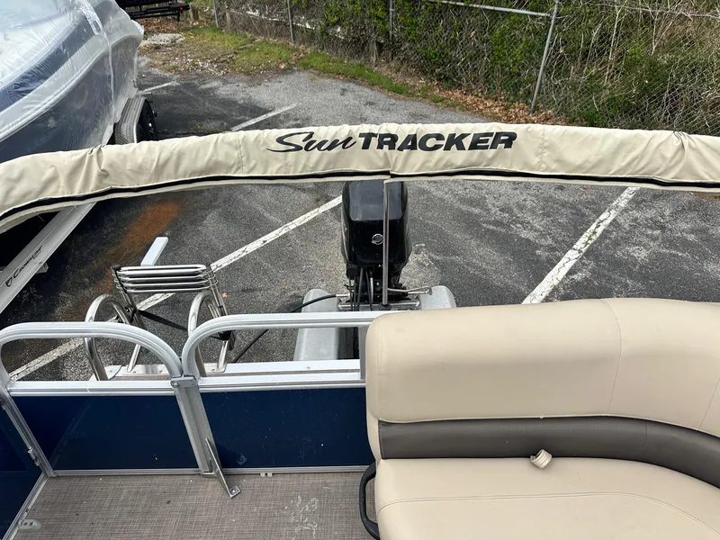 Slide: The Image of 2023 Sun Tracker Bass Buggy 16 XL Select pontoon boat interior with seating and motor. - 11