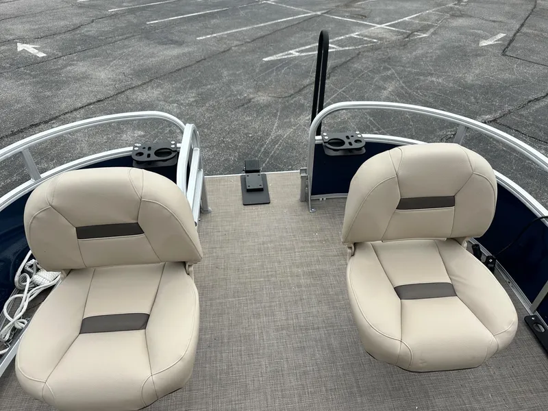 Slide: The Image of 2023 Sun Tracker Bass Buggy 16 XL Select with beige seats in a parking lot. - 13