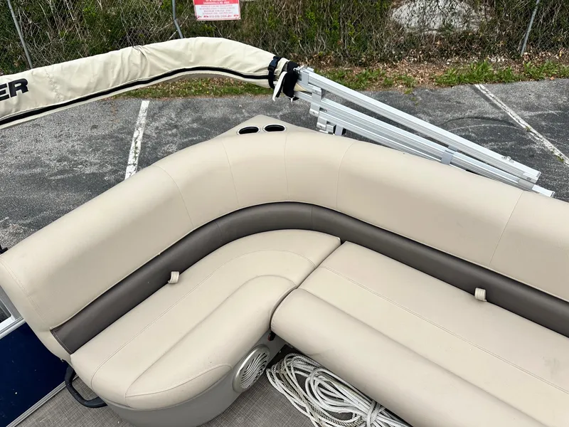 Slide: The Image of 2023 Sun Tracker Bass Buggy 16 XL Select pontoon boat with beige seating and cup holders. - 15
