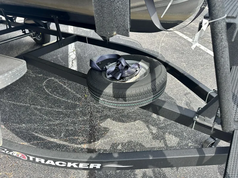 Slide: The Image of 2023 Sun Tracker Bass Buggy 16 XL Select trailer with spare tire and strap. - 21