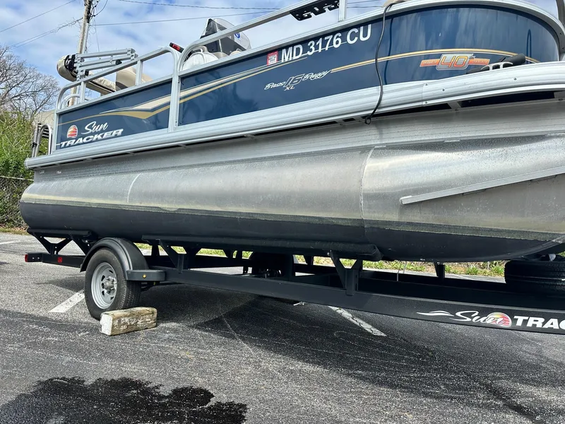 Slide: The Image of 2023 Sun Tracker Bass Buggy 16 XL Select pontoon boat on trailer in parking lot. - 7