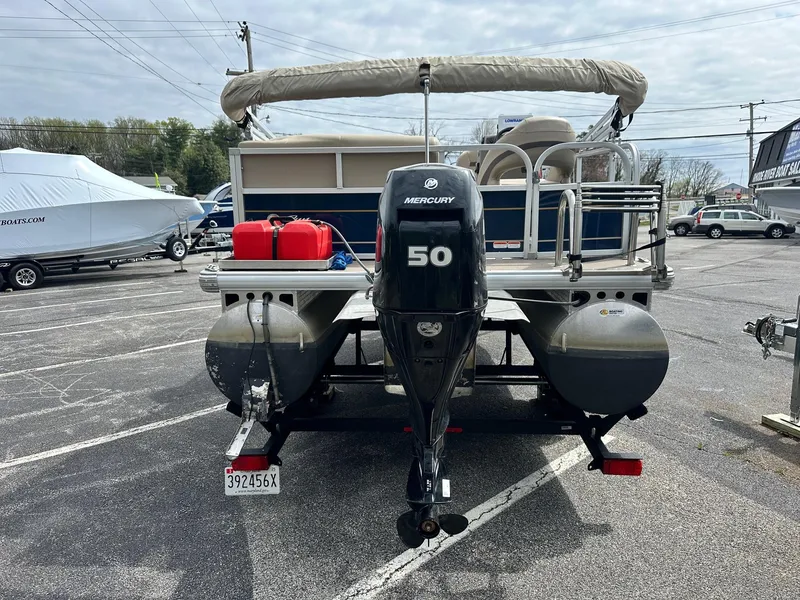 Slide: The Image of 2023 Sun Tracker Bass Buggy 16 XL Select pontoon boat with Mercury 50 engine in parking lot. - 8