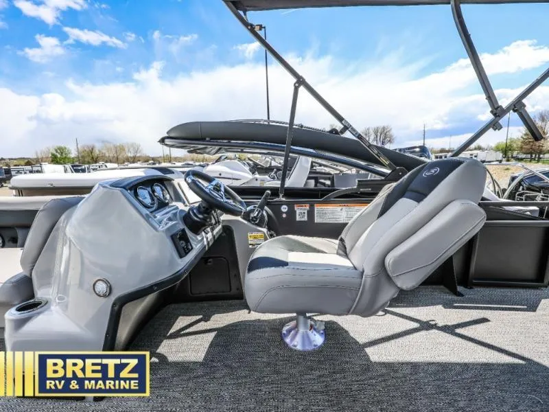 Slide: The Image of 2025 Aria Ultra-Lounge A22UC boat interior with steering console and captain's chair. - 14