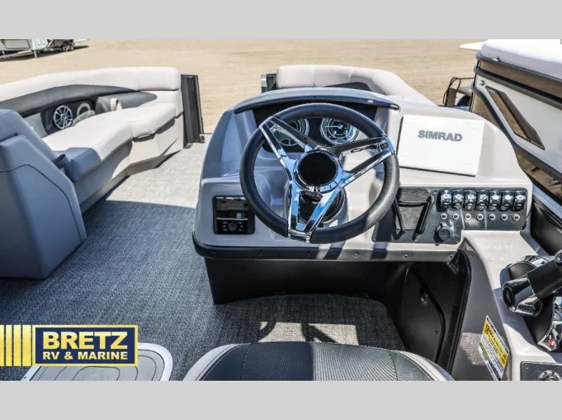 Slide: The Image of 2025 Aria Ultra-Lounge A22UC boat dashboard with steering wheel and controls, displayed by Bretz RV & Marine. - 15
