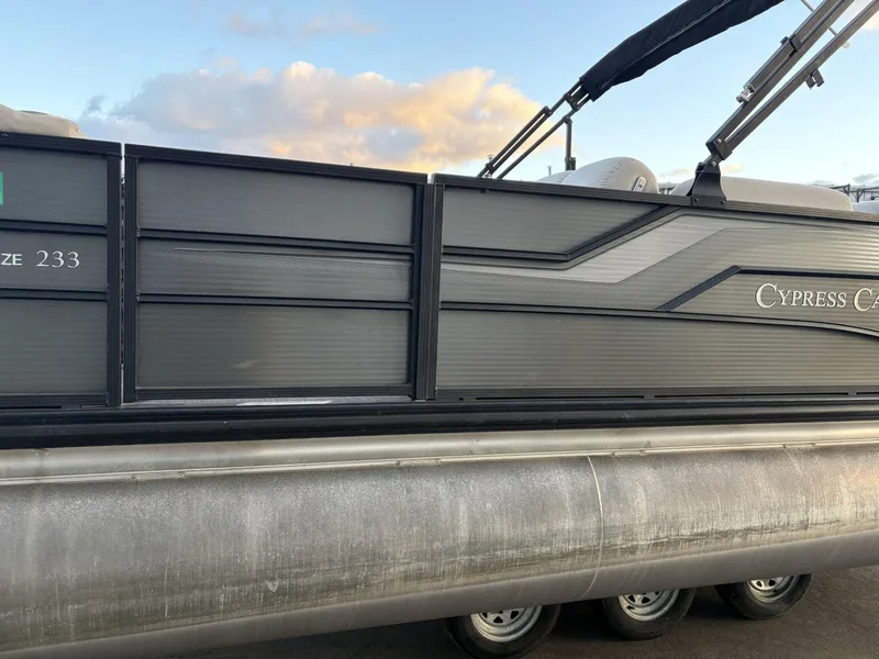 Slide: The Image of 2018 Cypress Cay Seabreeze 233 pontoon boat with sleek black exterior design. - 12