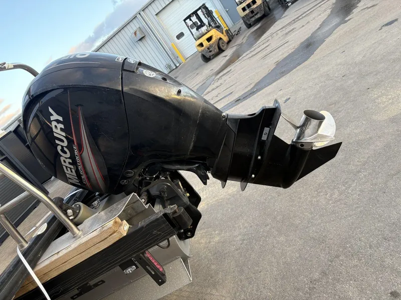 Slide: The Image of 2018 Cypress Cay Seabreeze 233 with Mercury outboard motor in a boatyard setting. - 13