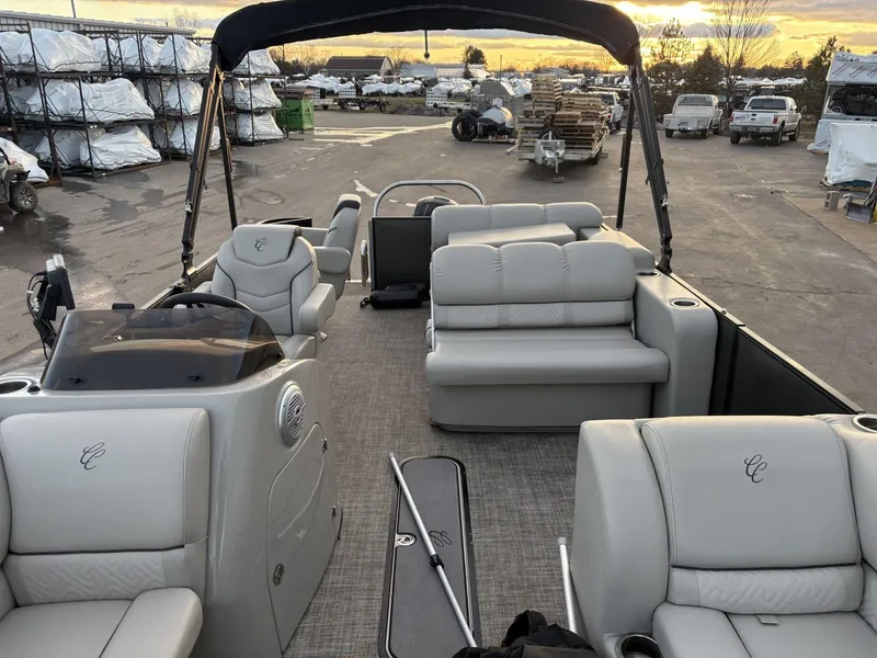 Slide: The Image of 2018 Cypress Cay Seabreeze 233 pontoon boat with plush seating and canopy at sunset. - 14