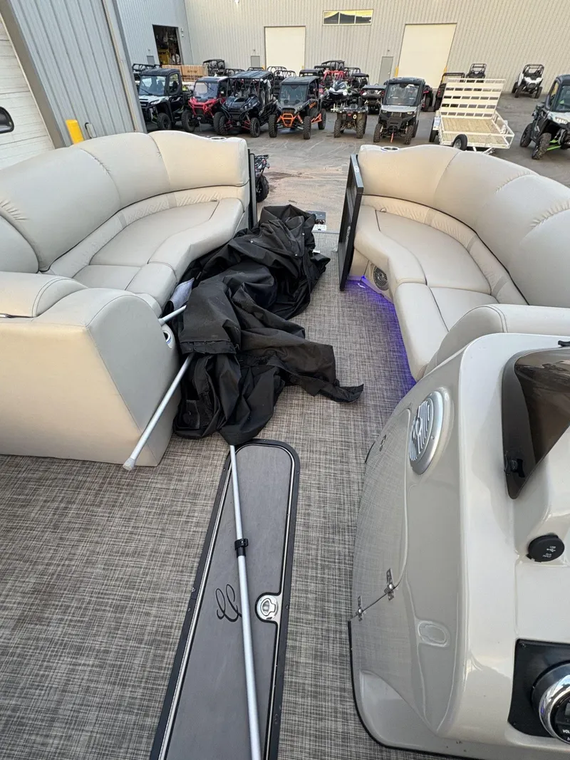 Slide: The Image of 2018 Cypress Cay Seabreeze 233 pontoon boat interior with beige seating and equipment. - 17