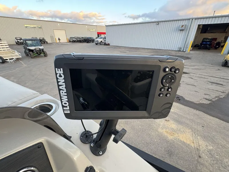 Slide: The Image of Lowrance fish finder on 2018 Cypress Cay Seabreeze 233 boat, parked near industrial buildings. - 18