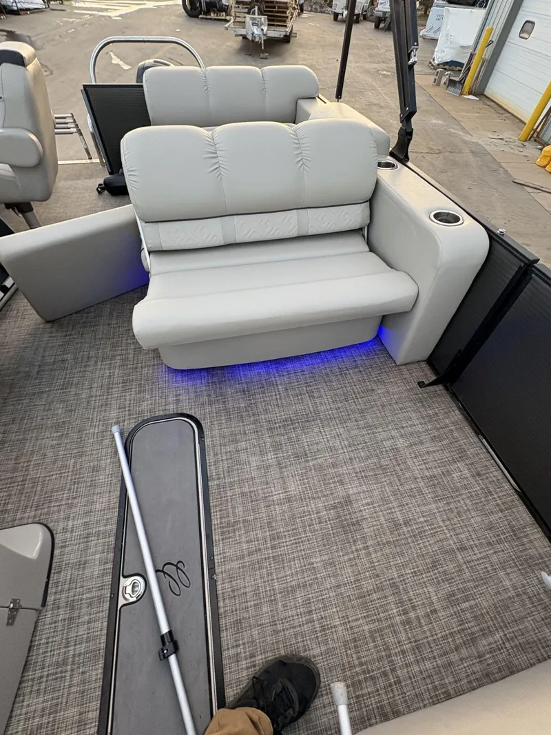 Slide: The Image of 2018 Cypress Cay Seabreeze 233 boat interior with gray seating and blue LED lighting. - 19