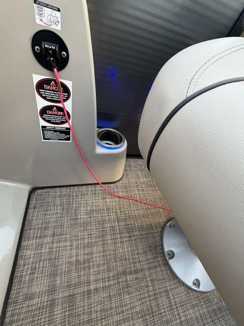 Slide: The Image of Interior of 2018 Cypress Cay Seabreeze 233 boat with safety lanyard and warning labels. - 20