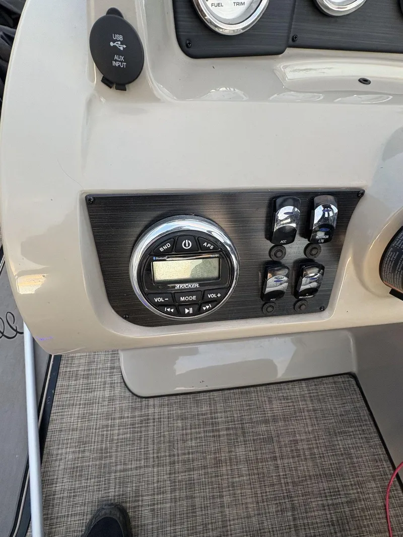 Slide: The Image of Control panel of 2018 Cypress Cay Seabreeze 233 boat with audio system and switches. - 21