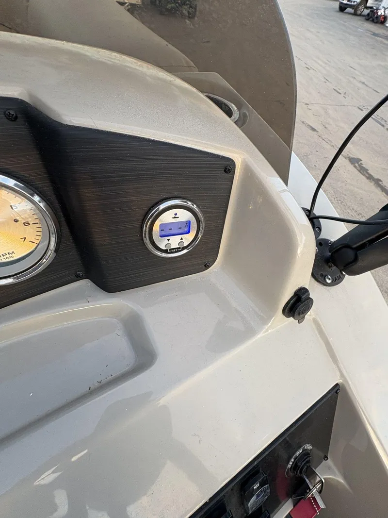 Slide: The Image of Dashboard of a 2018 Cypress Cay Seabreeze 233 boat with gauges and controls. - 23