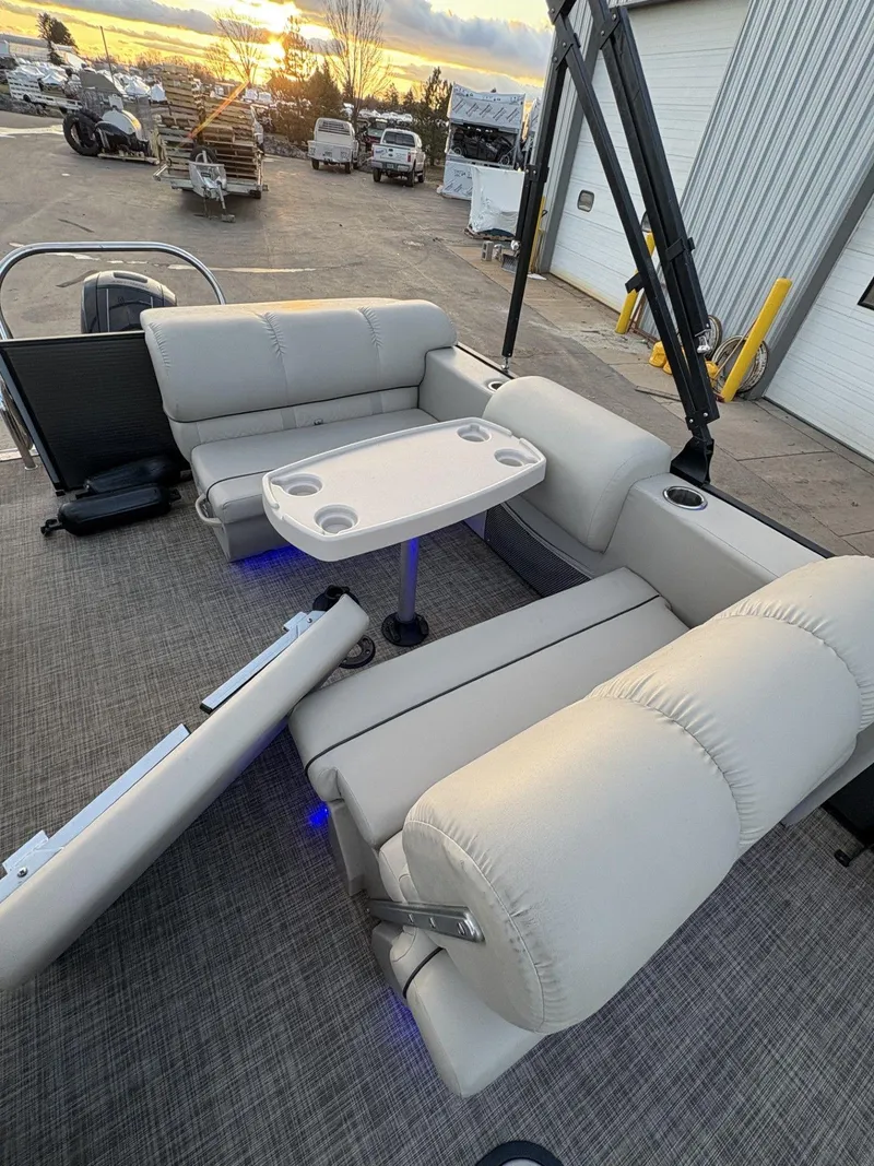 Slide: The Image of 2018 Cypress Cay Seabreeze 233 pontoon boat interior with plush seating and table. - 24