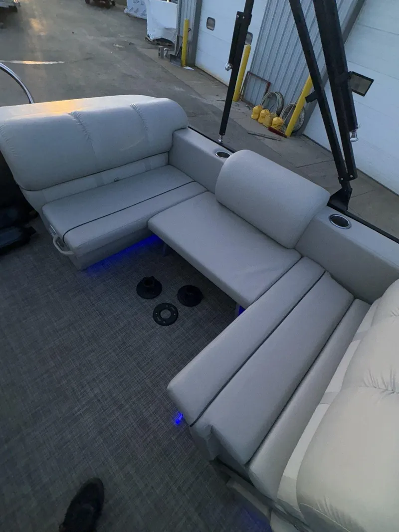 Slide: The Image of 2018 Cypress Cay Seabreeze 233 pontoon boat interior with gray seating and blue LED lighting. - 27