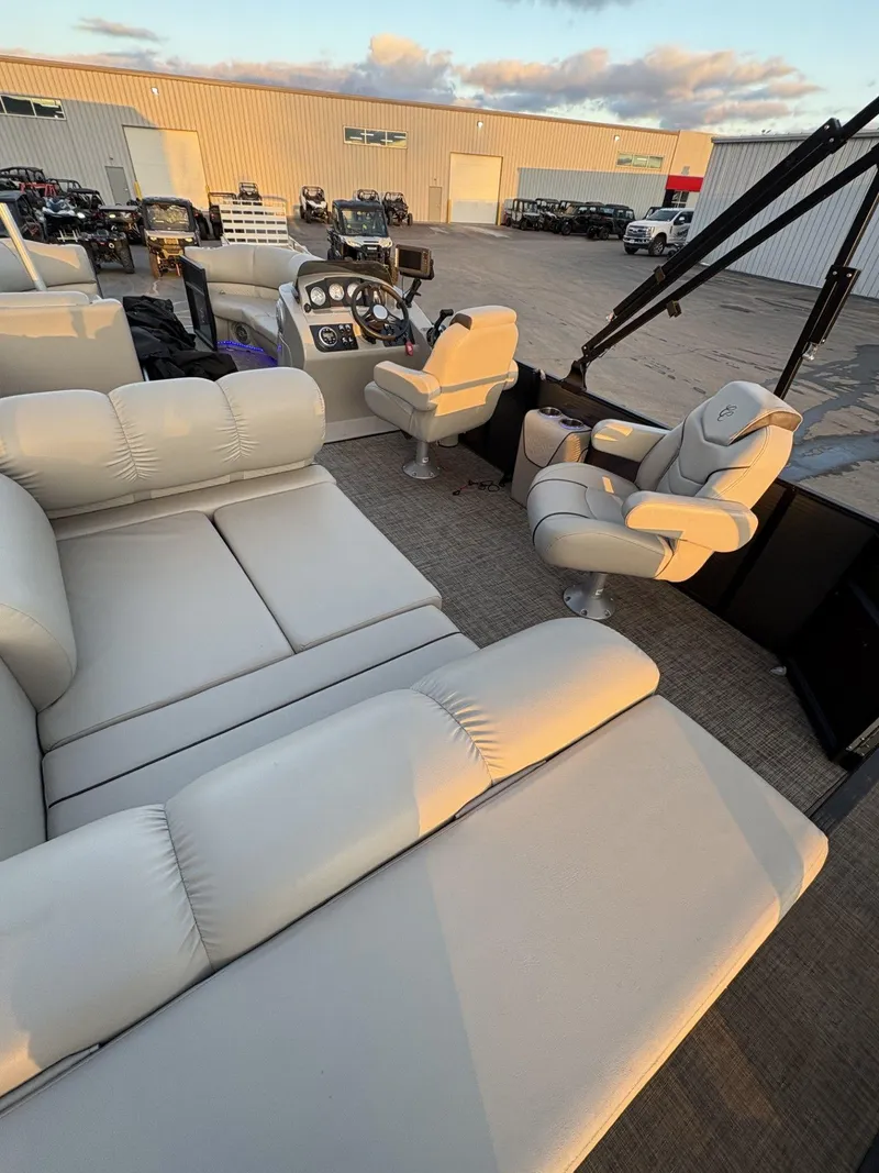 Slide: The Image of 2018 Cypress Cay Seabreeze 233 pontoon boat interior with plush seating and helm. - 29