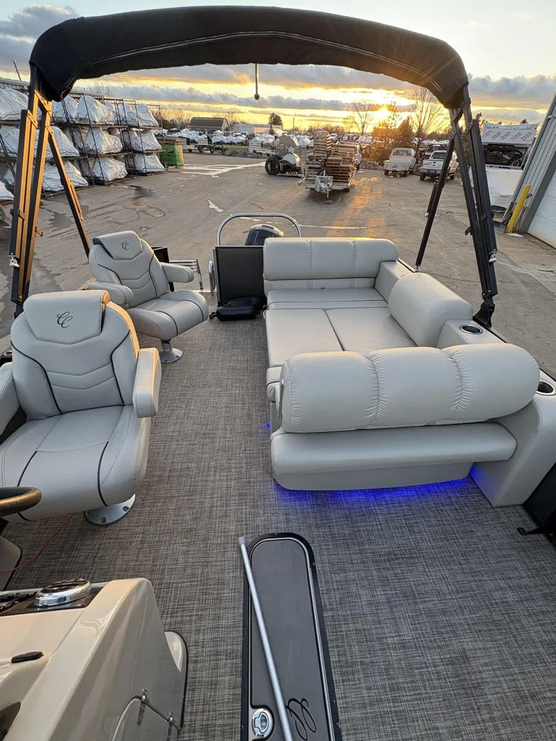 Slide: The Image of 2018 Cypress Cay Seabreeze 233 pontoon boat interior with plush seating and sunset view. - 30