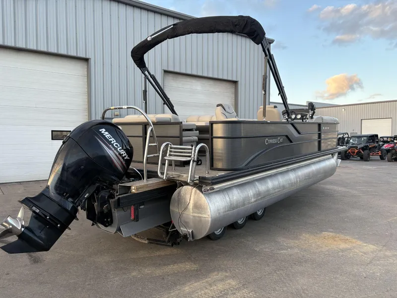 Slide: The Image of 2018 Cypress Cay Seabreeze 233 pontoon boat with Mercury outboard motor, parked outdoors. - 6