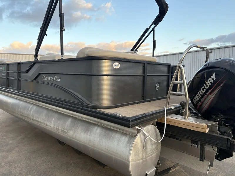 Slide: The Image of 2018 Cypress Cay Seabreeze 233 pontoon boat with Mercury engine, docked outdoors. - 7